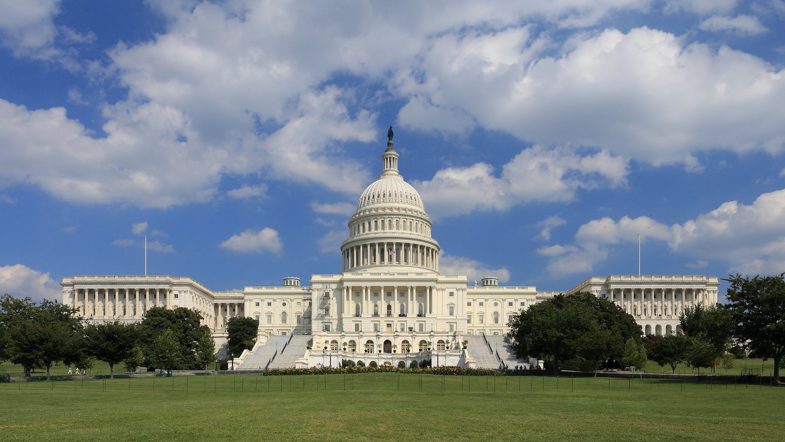 The United States Capitol west front under a blue summer sky