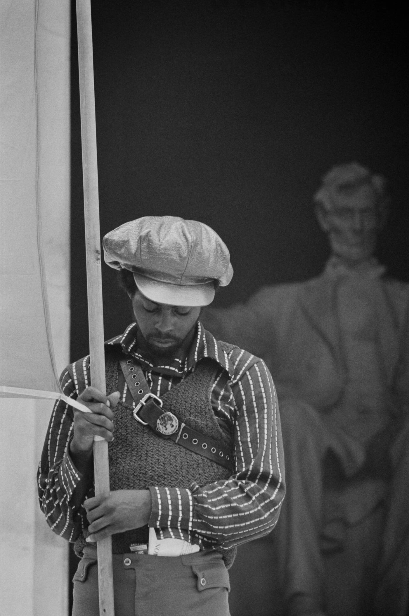 June 19, 1970: a member of the Black Panther Party holding a banner for the Revolutionary People's Constitutional Convention in front of the Lincoln Memorial.
