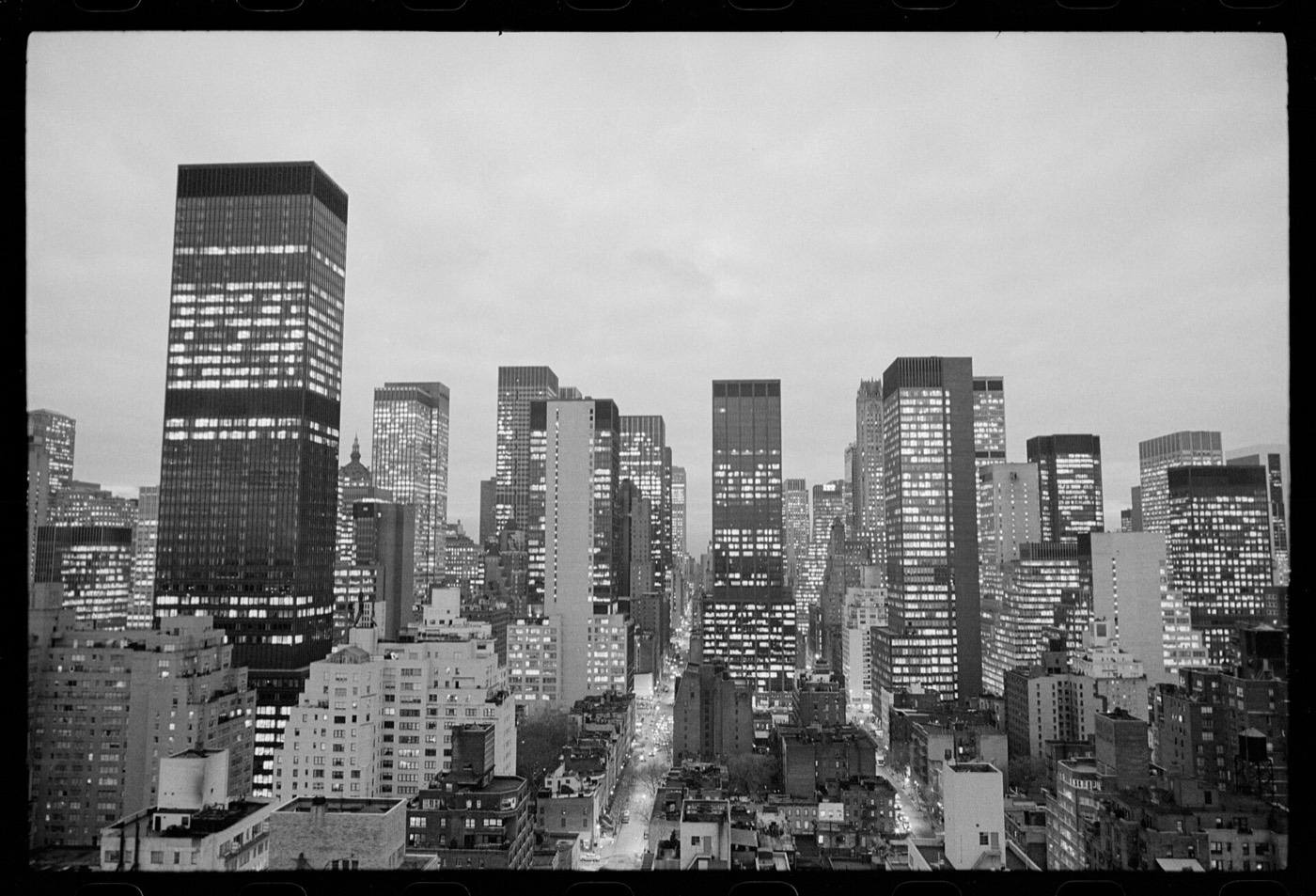Photograph shows skyscrapers of the New York City skyline.Midtown Manhattan, likely shot from aircraft over the East River between 48th and 49th Streets.