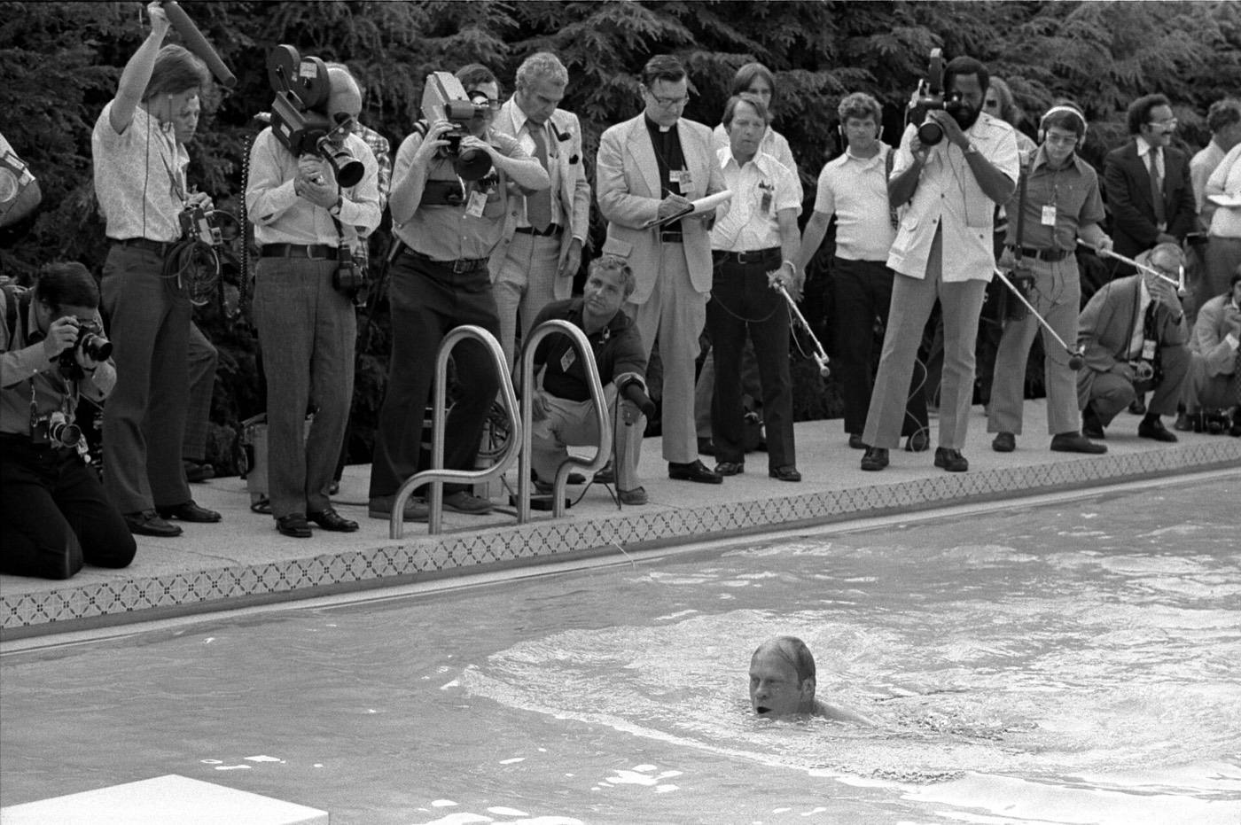 President Gerald Ford takes his first swim in the new White House pool.