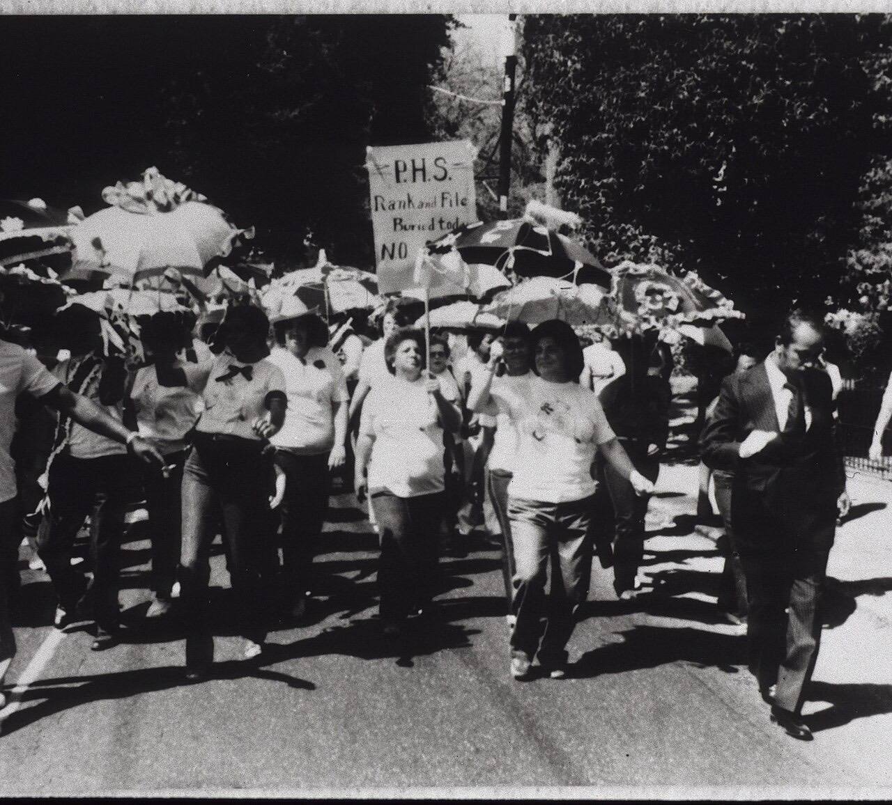 New Orleans Marine Hospital, 1981. "Jazz funeral" style procession to mourn closing of Public Health Service Marine Hospital. Participants second lining with um