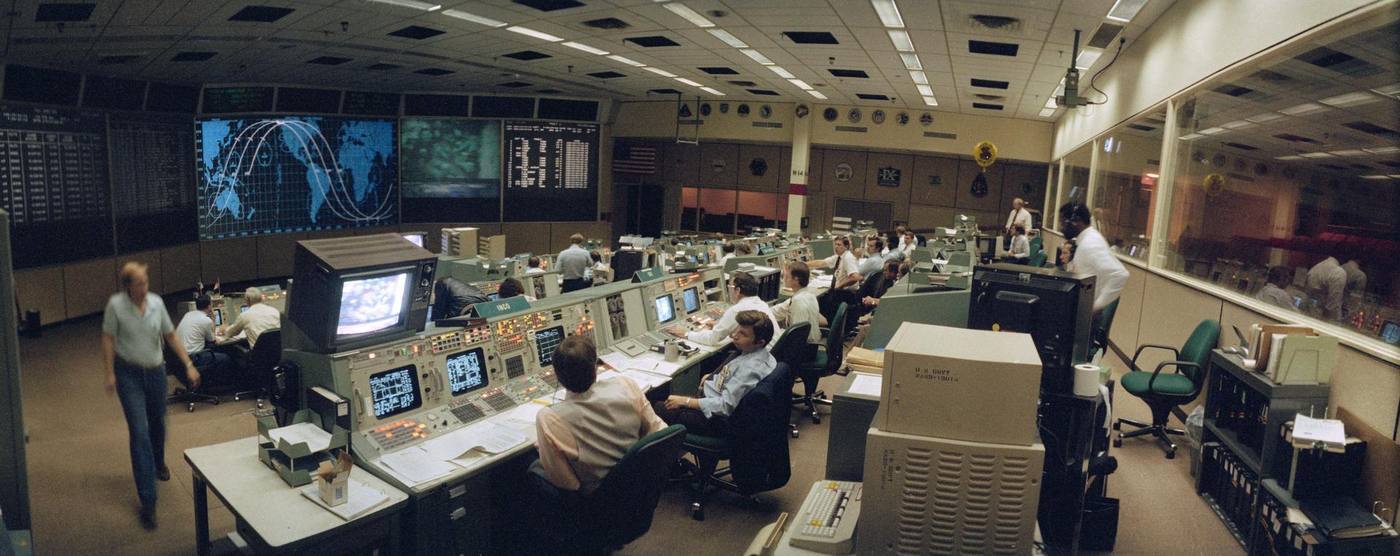 Wide angle view of the flight control room (FCR) of the Mission Control Center (MCC).