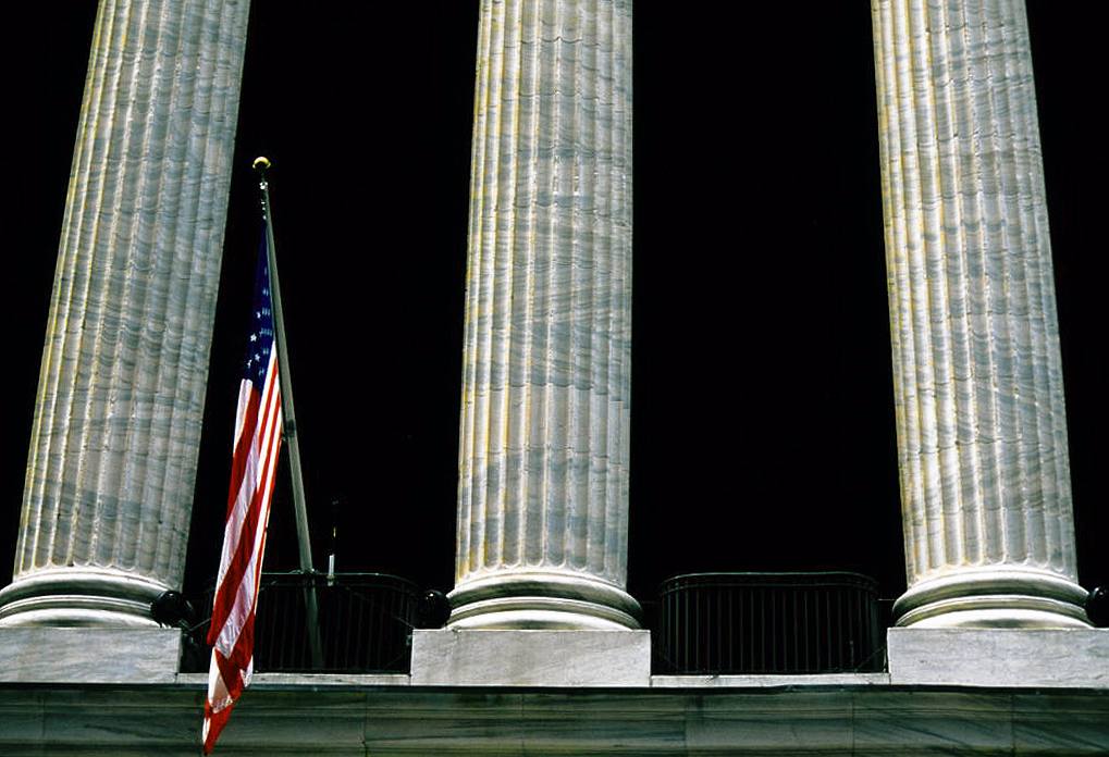 Columns and flag of the New York Stock Exchange Building; Wall Street, Manhattan, New York City, NY, United States