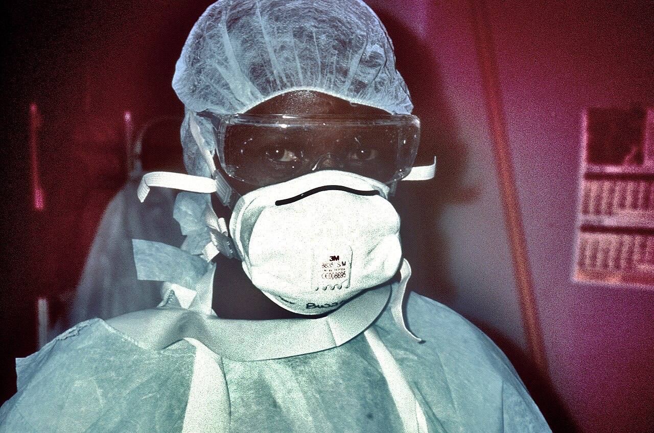 This 1995 photograph shows a nurse with personal protective equipment (PPE) prepared to enter the Ebola VHF isolation ward during Ebola virus disease outbreak i
