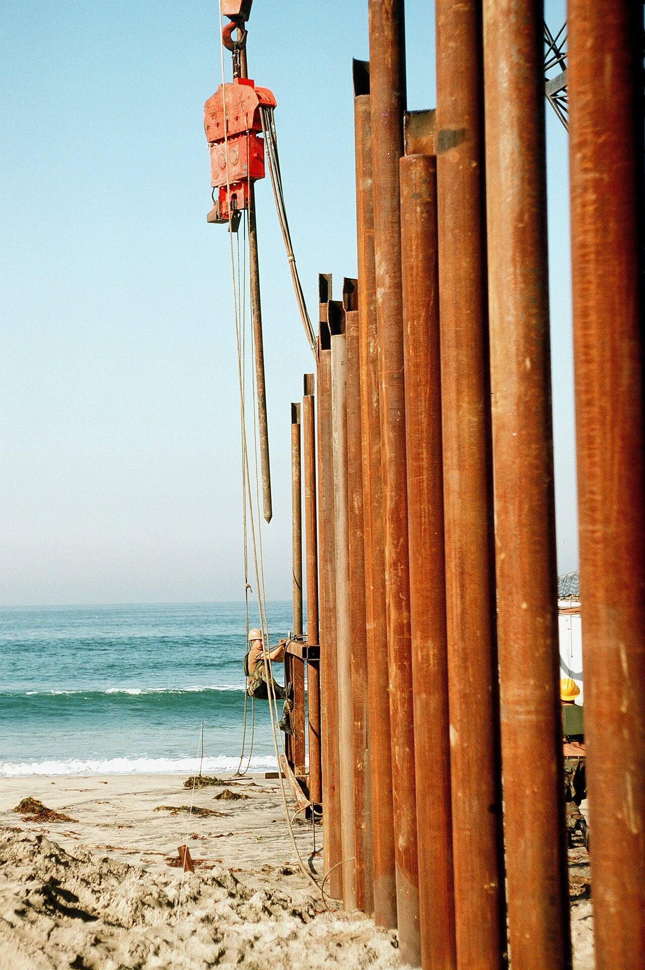 U.S. Army Corps of Engineers from the 497th Engineering Company, based at Fort Eustis, VA, construct an extension to the international border fence separating t