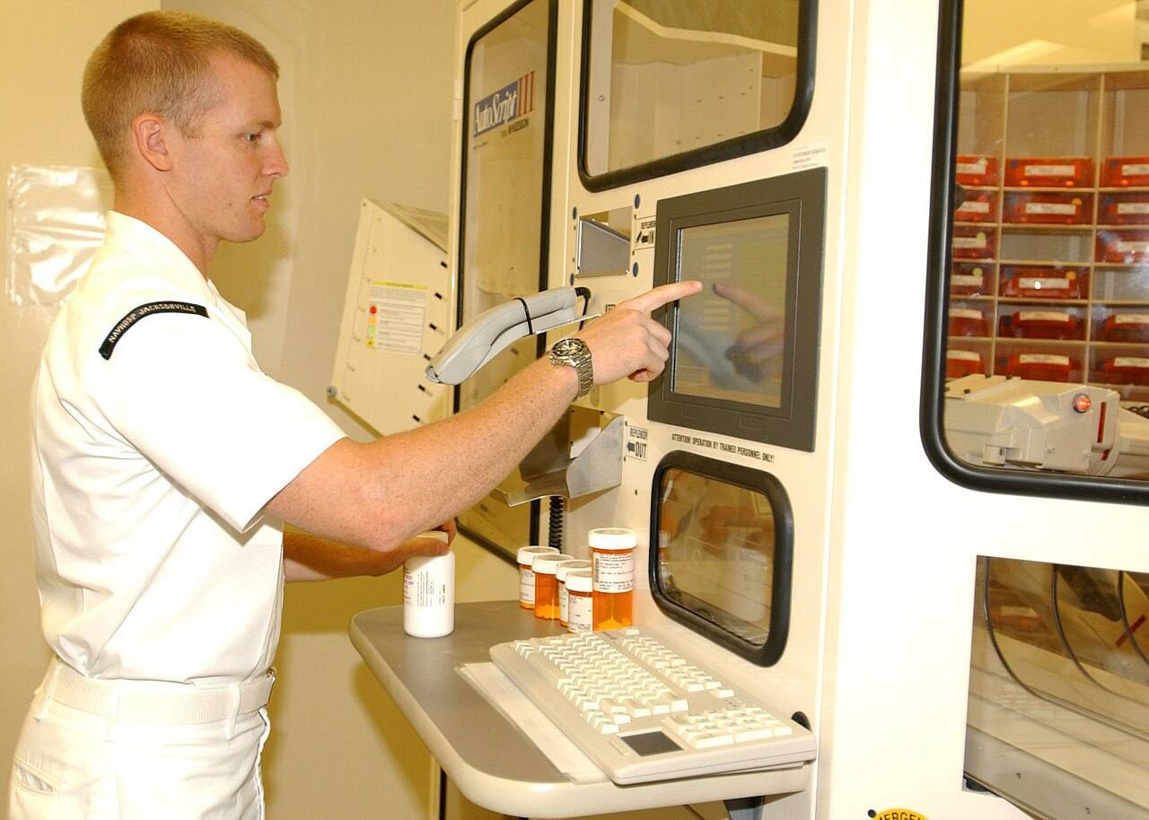 US Navy 030710-N-8102J-005 Hospital Corpsman 3rd Class Kenneth Hughes from Merrit Island, Fla., activates the pharmacy's new Autoscript III tablet and capsule d