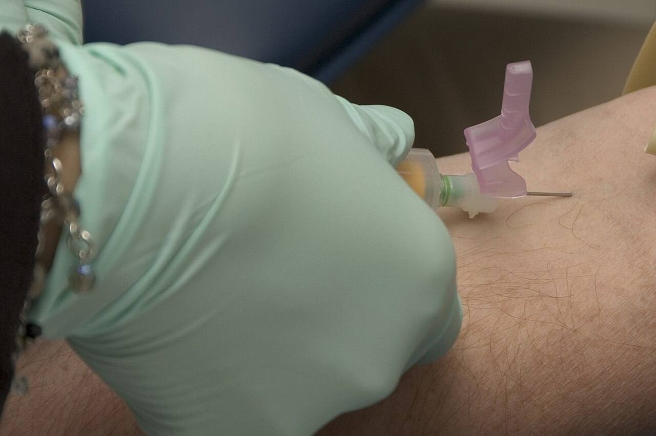 US Navy 051128-N-2115M-011 Medical Technologist Jezieca Cechero assigned to the David R. Ray Health Center's Laboratory department draws blood from a service me