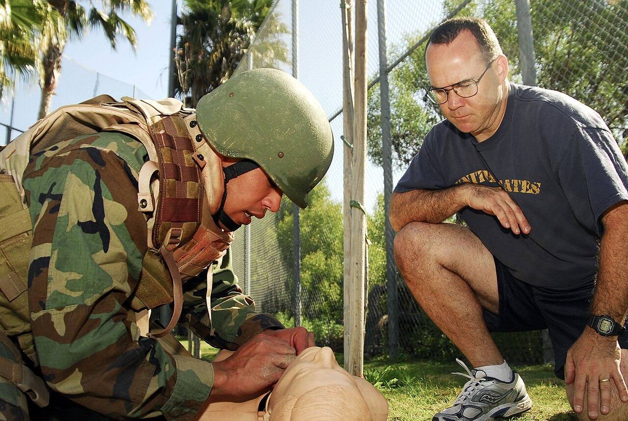 US Navy 090327-N-5617R-121 Chief Hospital Corpsman James Ward watches Hospital Corpsman 2nd Class Mervin Santos perform a trachiotomy to open the airway of a me