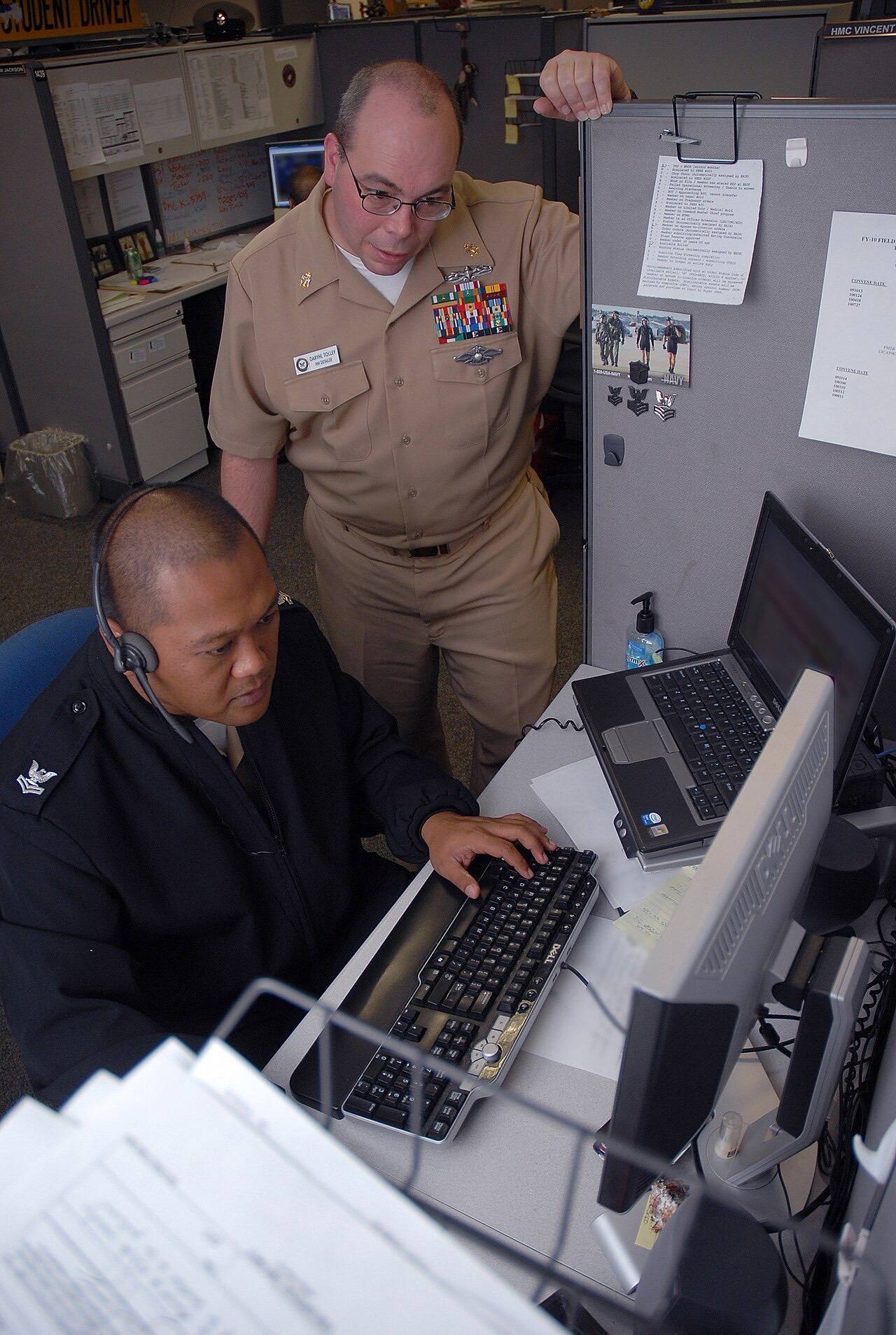 US Navy 091117-N-0659H-010 Chief Hospital Corpsman Daryhl Tolley gives Hospital Corpsman 2nd Class Ramon Eusebio permission to process a set of permanent change