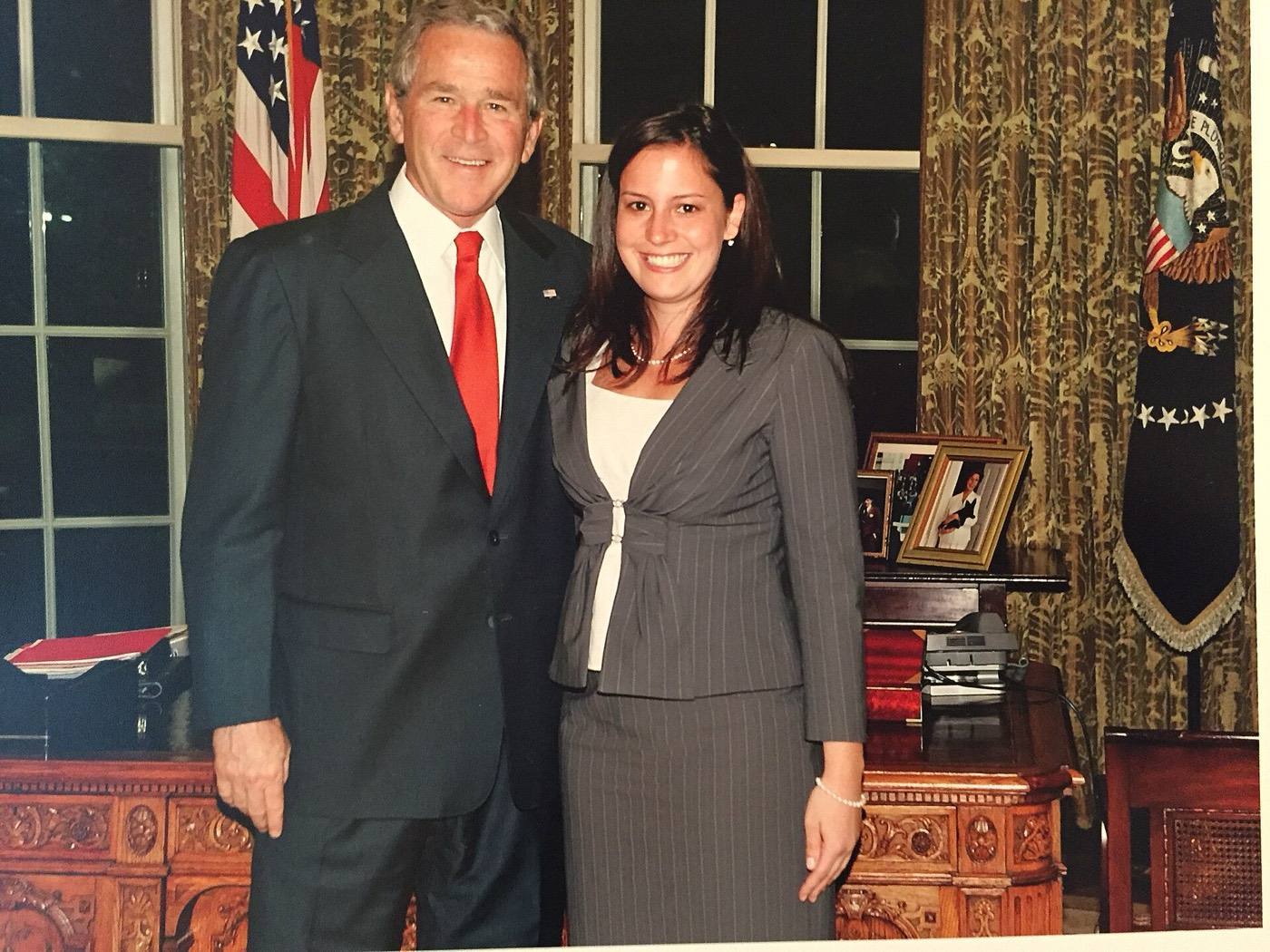 Elise Stefanik posing with President George W. Bush in the Oval Office during the 2000s.