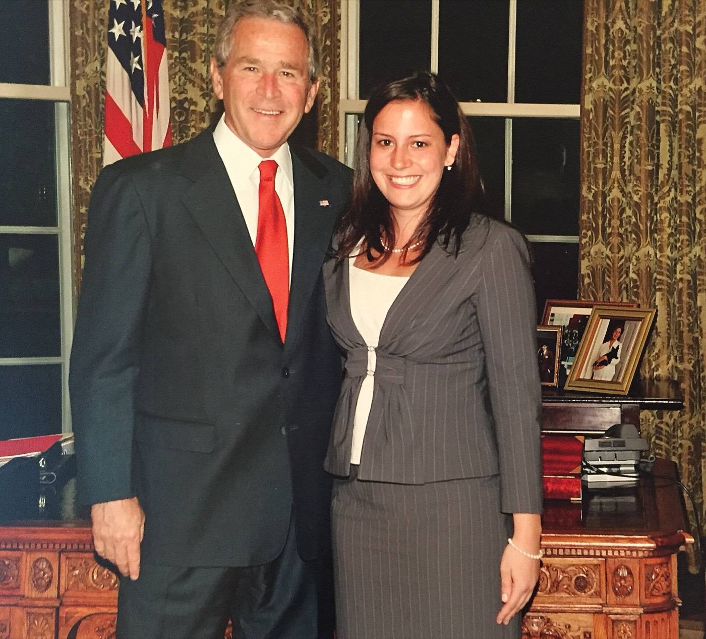 Elise Stefanik posing with President George W. Bush in the Oval Office during the 2000s.