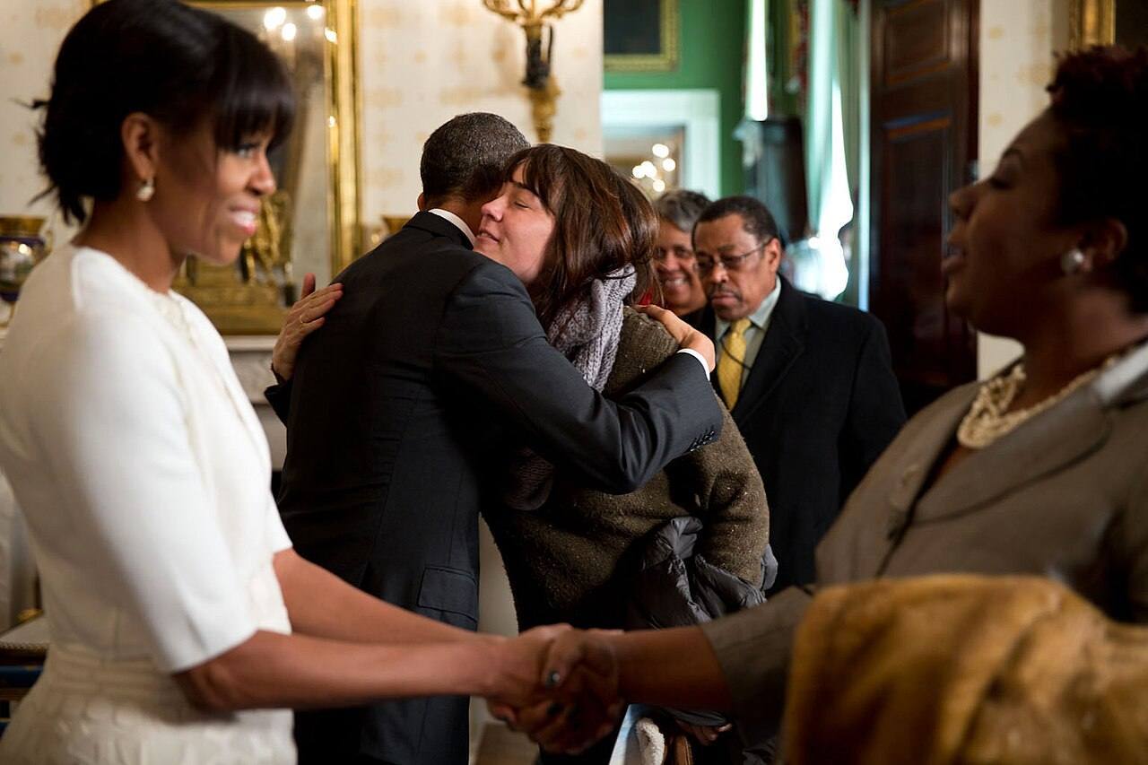 United States President Barack Obama and First Lady Michelle Obama greet visitors during an inaugural open house in the Blue Room of the White House on 22 Janua