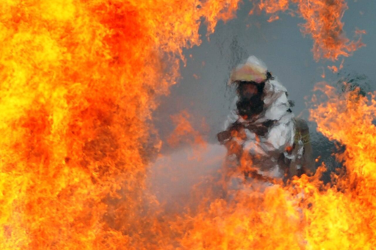 Defense.gov News Photo 120723-F-HA794-089 - A U.S. Air Force firefighter sprays water at the fire of a simulated C-130 Hercules plane crash during operational r