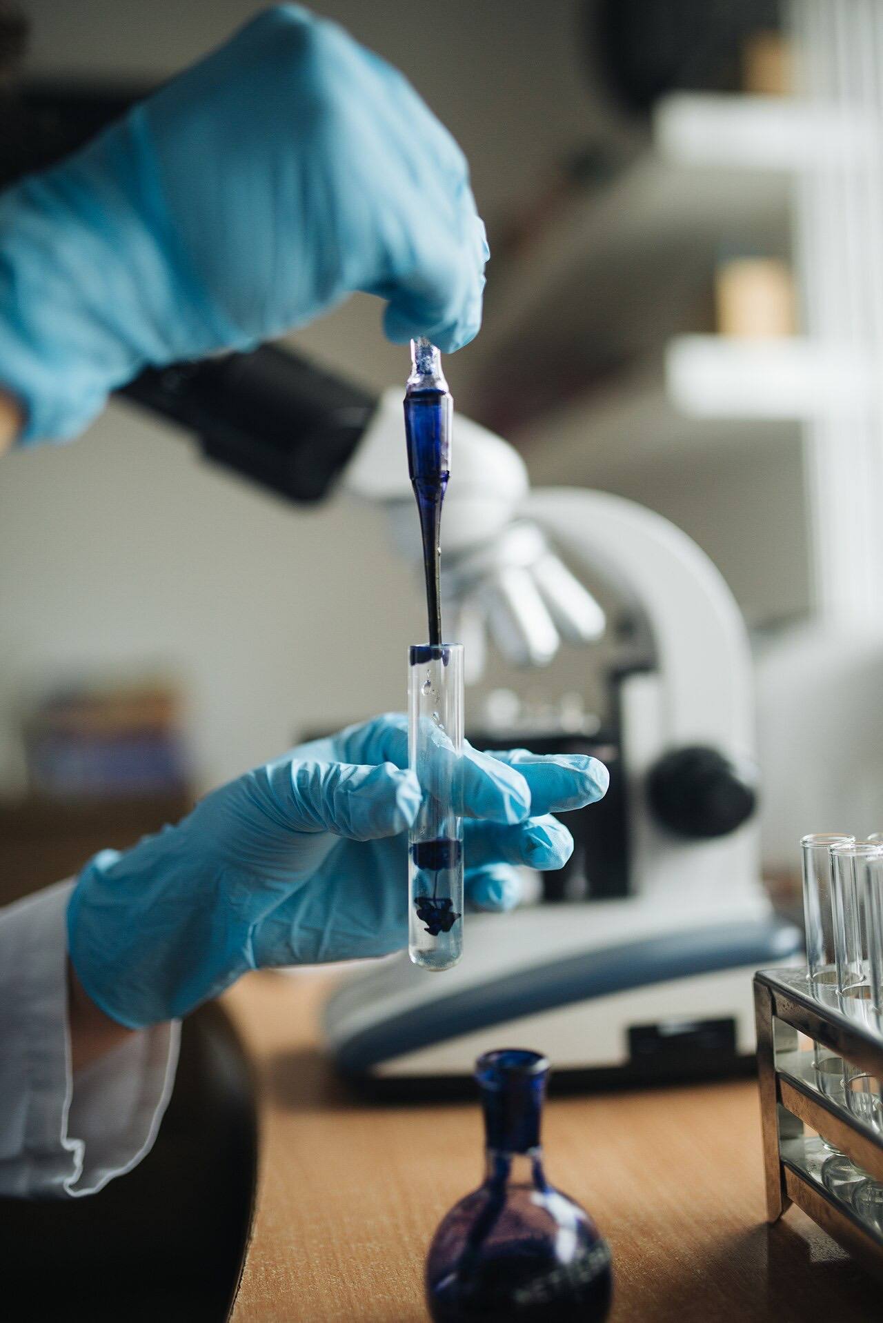 Close-up of a lab technitian dissolving ink in water