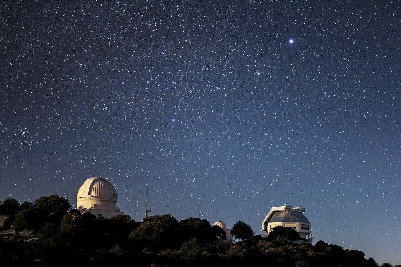 Starry sky over the WIYN 3.5-meter Telescope and the WIYN 0.9-meter Telescope telescope at Kitt Peak National Observatory near Tucson, AZ.